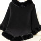 Cozy black Bella Road poncho with fuzzy trim, perfect for chilly days and stylish layering.