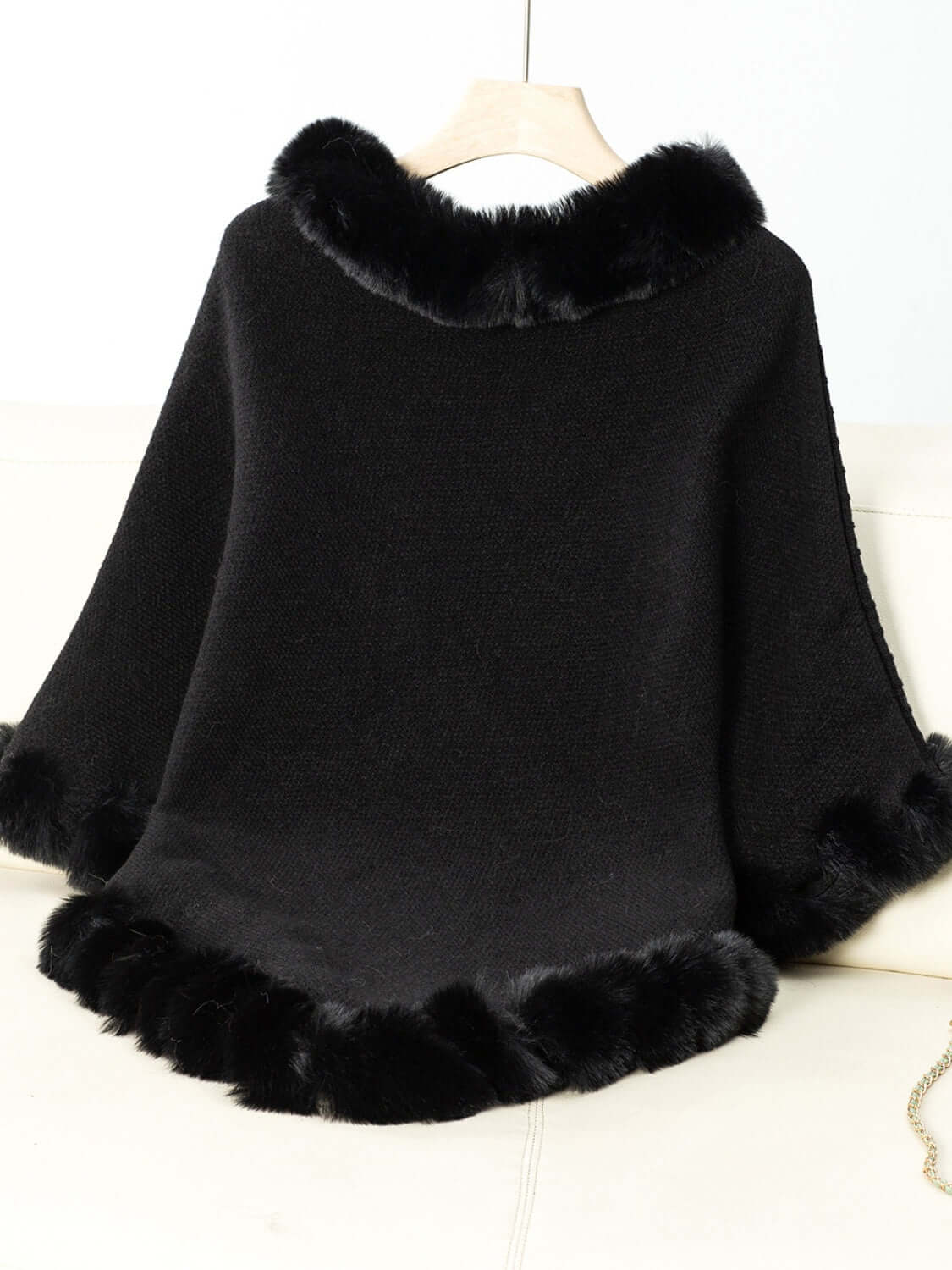 Cozy black Bella Road poncho with fuzzy trim, perfect for chilly days and stylish layering.