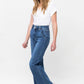 Woman wearing Judy Blue full size high rise double button wide leg jeans with a white top, showcasing stylish and comfortable fashion.