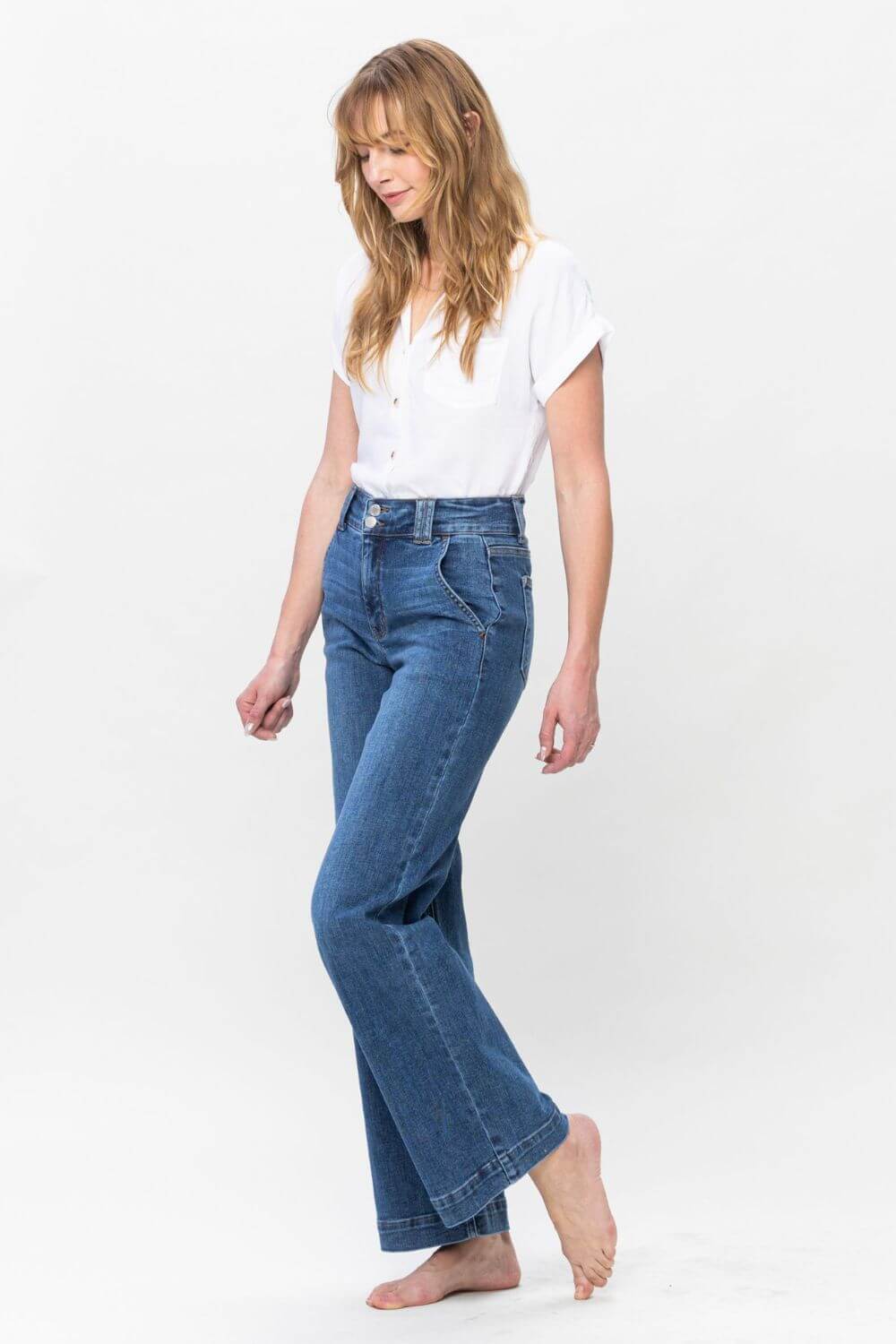 Woman wearing Judy Blue full size high rise double button wide leg jeans with a white top, showcasing stylish and comfortable fashion.