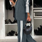 Model showcasing Bella Road Denim full-size contrast lapel collar top and pants set in gray with stylish stripes.