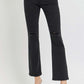 Black high-rise ankle bootcut jeans with wide waistband and distressed knees, styled with heels for a versatile fashion look.