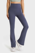 Woman wearing navy Millennia Elastic Waist Flare Yoga Pants, showcasing comfort and style for workouts.