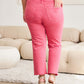 High-waisted raw hem pink jeans offering tummy control, shown with a casual top and wedges in a stylish setting - RFM Jeans