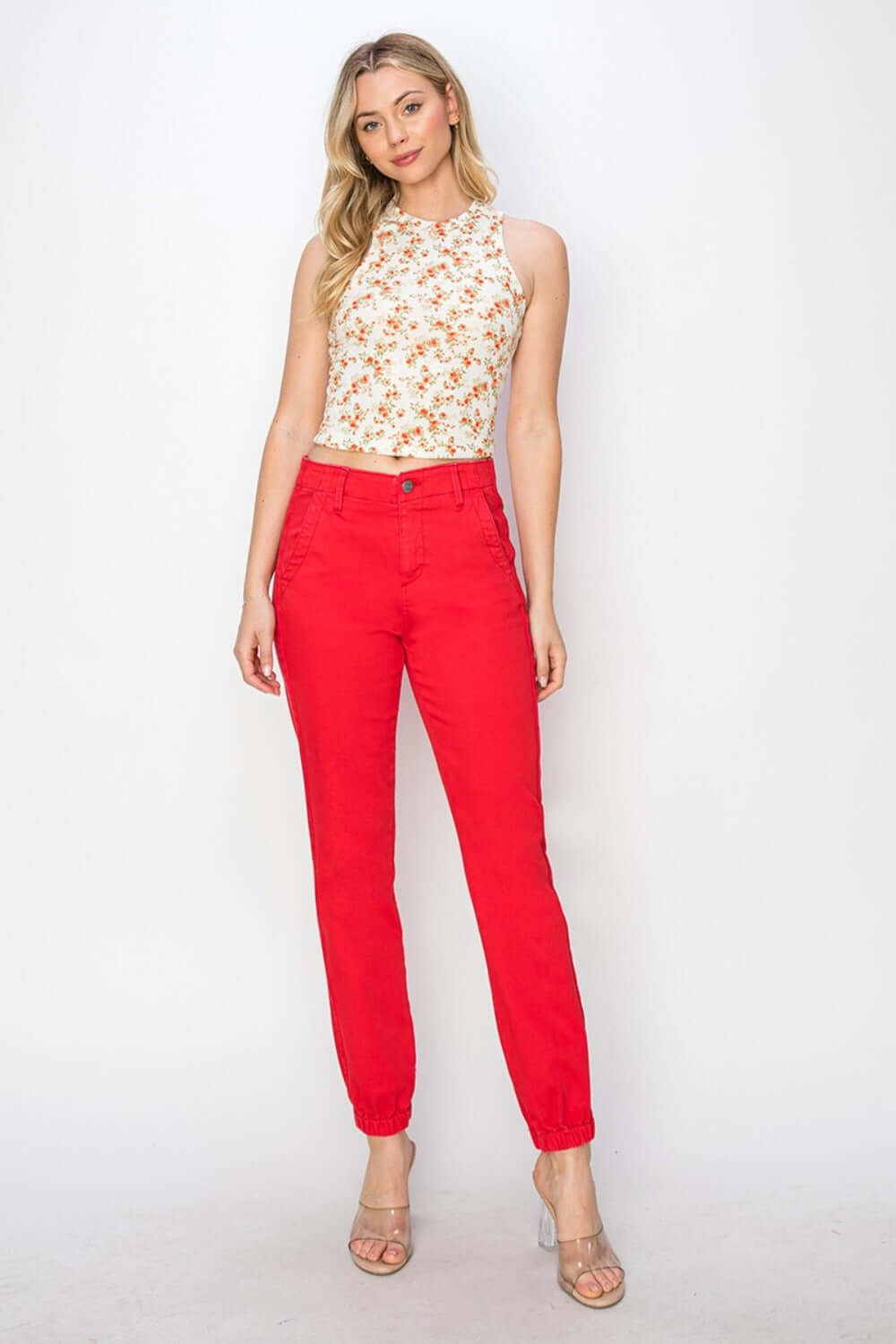 Woman wearing red high-waisted jogger jeans with floral top