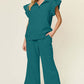 Woman wearing a teal Texture Ruffle Short Sleeve Top and Drawstring Wide Leg Pants Set with pockets.