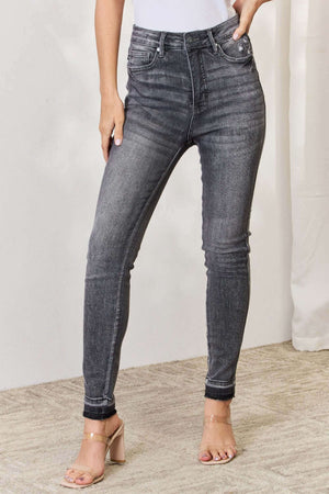 High Waist Tummy Control Release Hem Skinny Jeans by Judy Blue in dark wash, offering a flattering silhouette and premium stretch fabric.