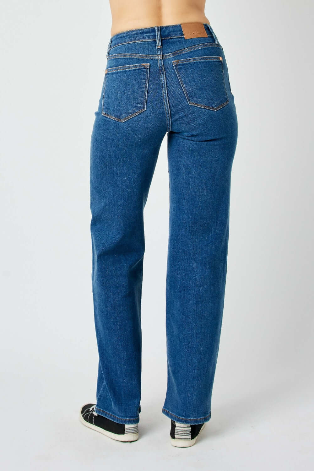 Back view of high rise straight Judy Blue jeans on a person, showcasing the flattering fit and streamlined silhouette.