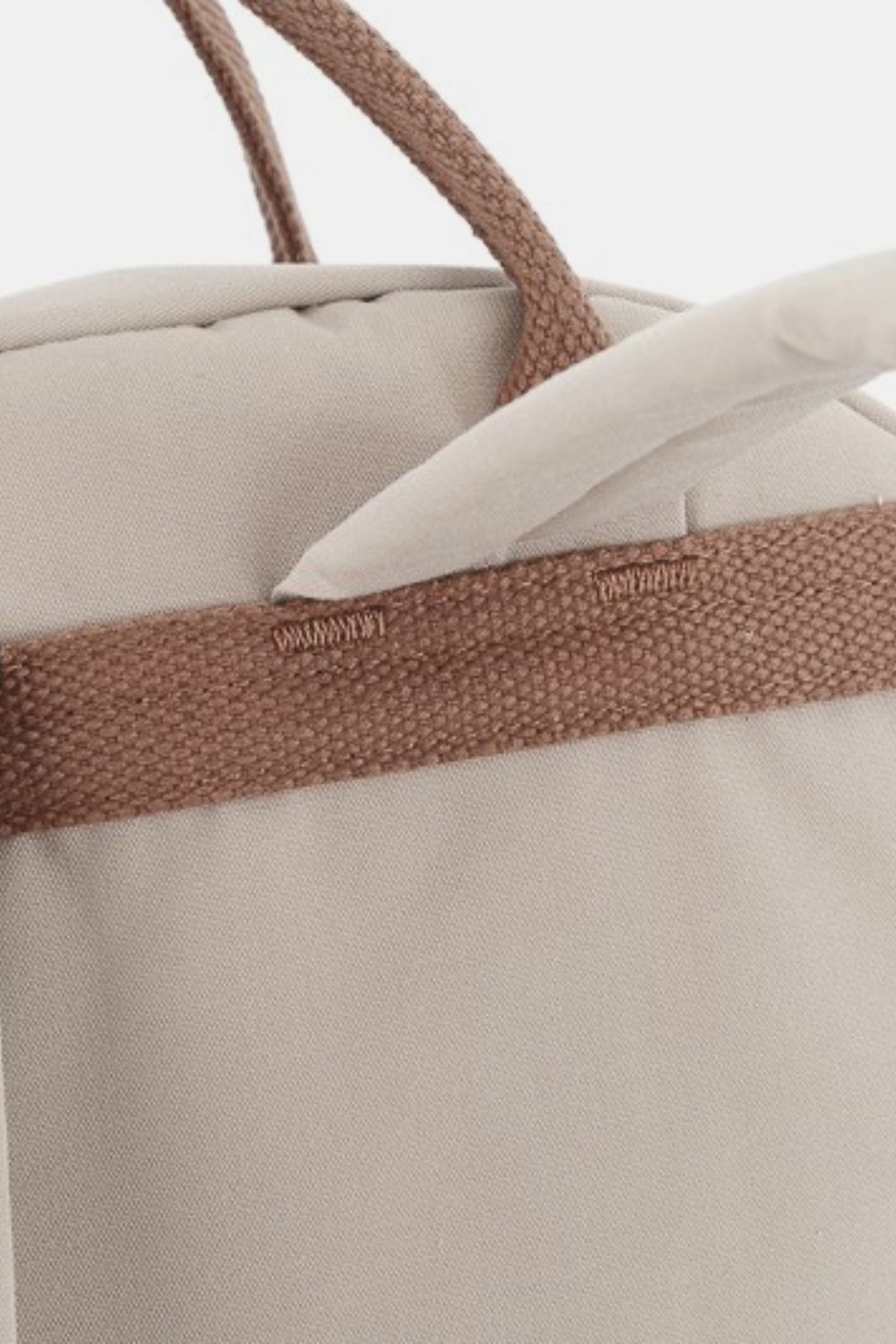 Close-up of beige Himawari waterproof backpack with durable fabric and handle detailing.