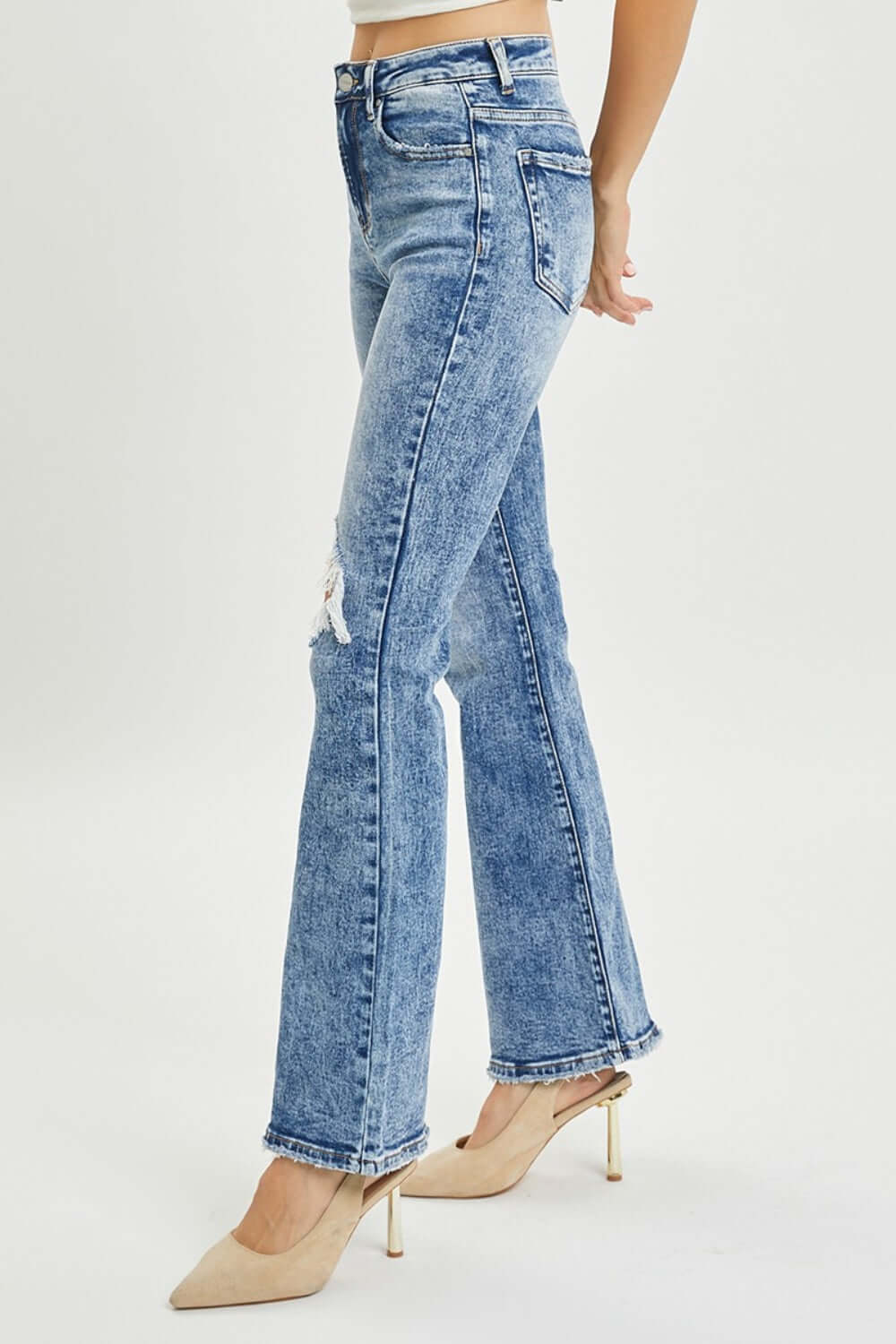 High-rise distressed flare jeans by Risen Jeans, showcasing a flattering fit, vintage-inspired distressed detailing, and 70s retro vibe.