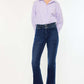 Woman wearing Kancan high-rise double waistband flare jeans in dark wash, showcasing sleek style and flattering fit.