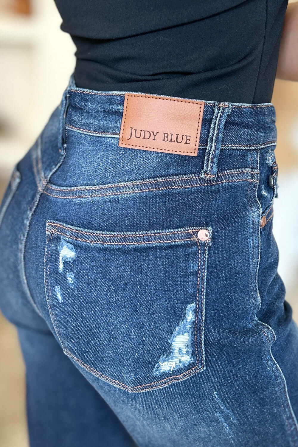 Close-up of High Waist Rigid Magic Heavy Destroy Judy Blue Jeans showcasing back pocket details and heavy distressing.