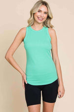 Woman wearing a Ribbed Round Neck Tank in light green paired with black shorts, perfect for casual or layered outfits.