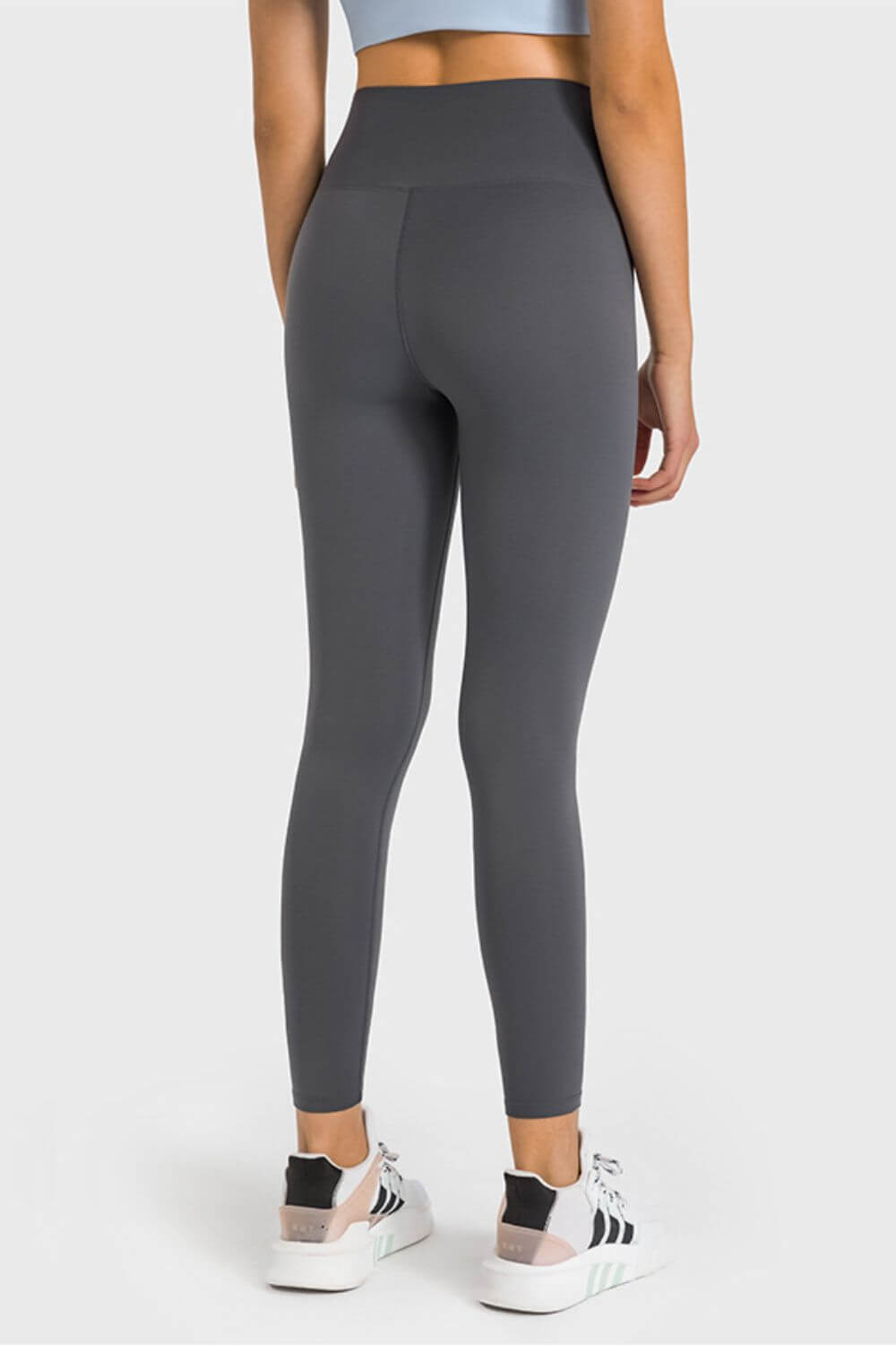 Back view of Millennia High Waist Ankle-Length Yoga Leggings in dark gray, showcasing comfort and style for yoga enthusiasts.