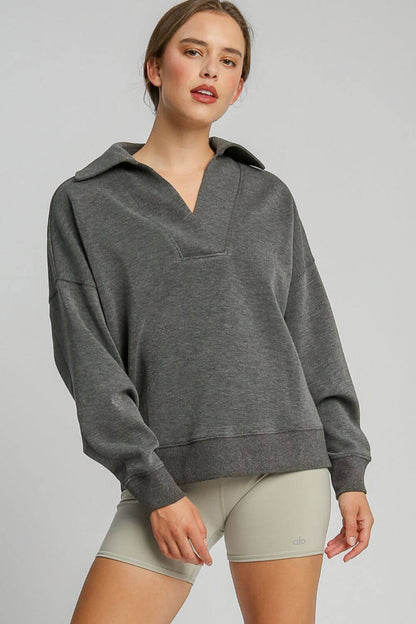 Woman wearing a stylish gray Johnny Collar Dropped Shoulder Sweatshirt, showcasing its relaxed fit and trendy design.