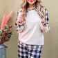 Relaxed model in drawstring hooded top and stylish plaid pants lounge set, perfect for comfort and chic style.