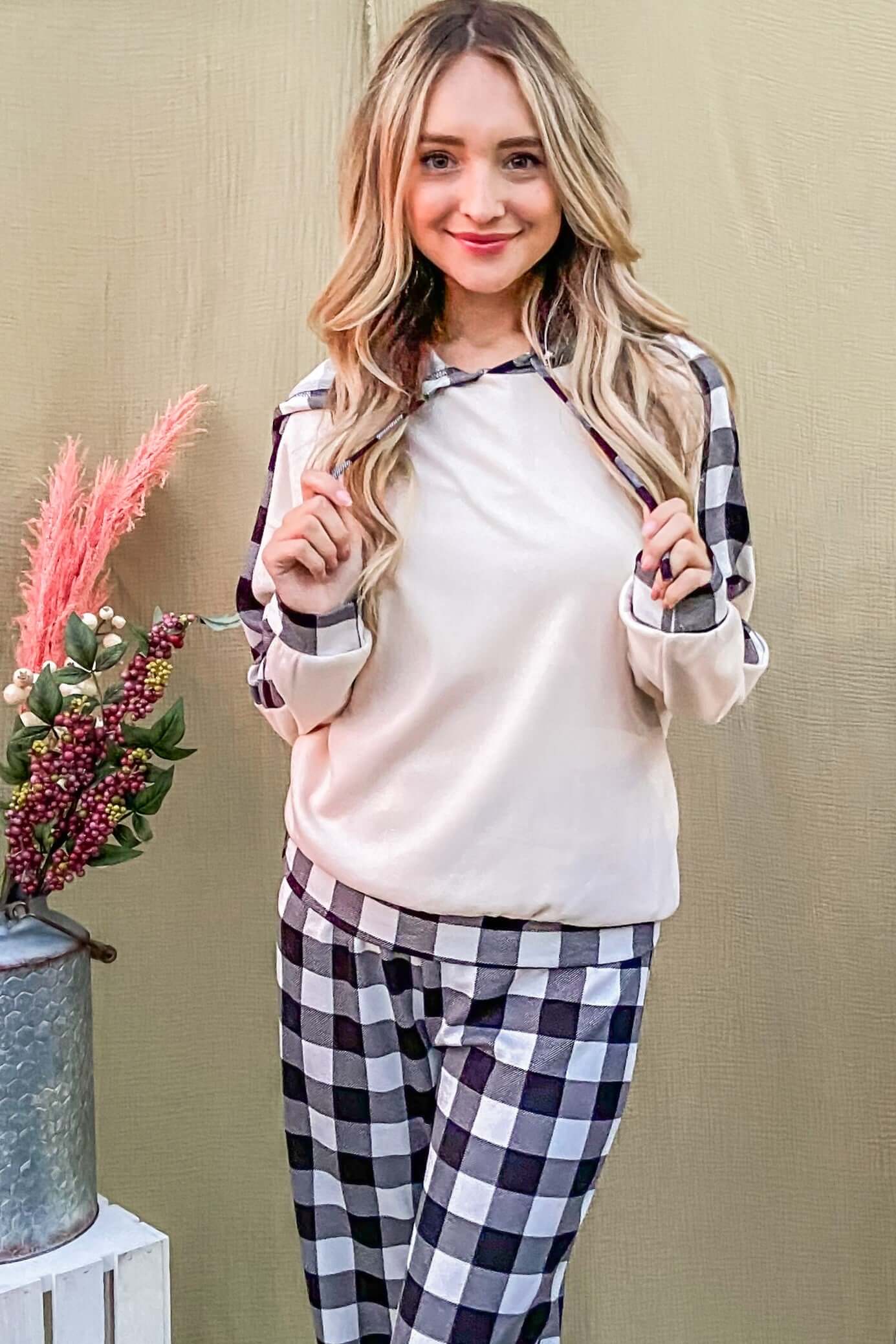 Relaxed model in drawstring hooded top and stylish plaid pants lounge set, perfect for comfort and chic style.