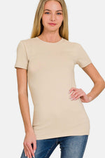 Beige crew neck short sleeve t-shirt for casual wear, paired with jeans, featuring a comfortable and breathable fabric.