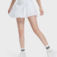 Active woman in a white pleated detail skirt, showcasing stylish comfort and flexibility for any activity.