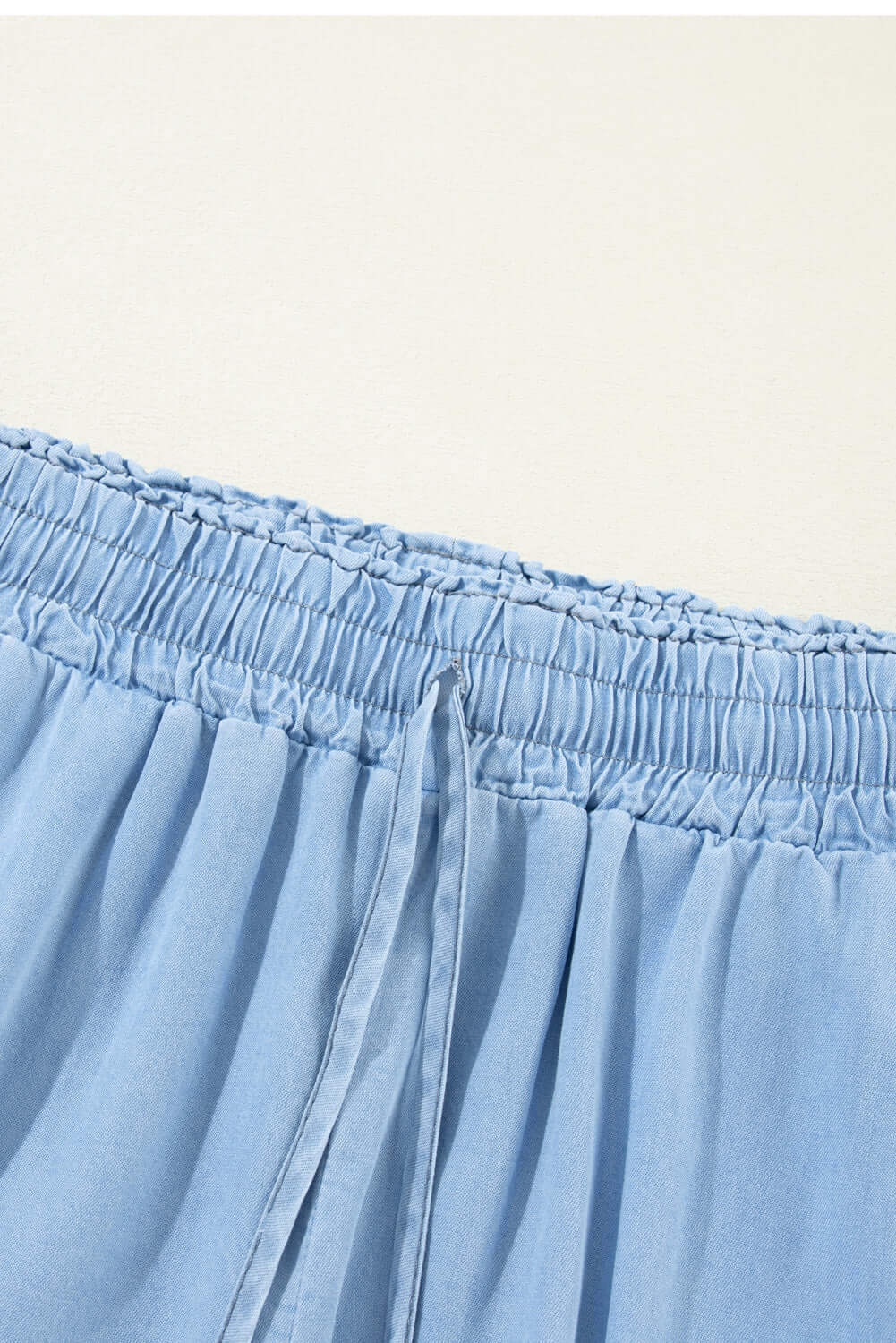 Close-up of the drawstring waist on Bella Road wide leg jeans in medium blue, showcasing comfort and style.