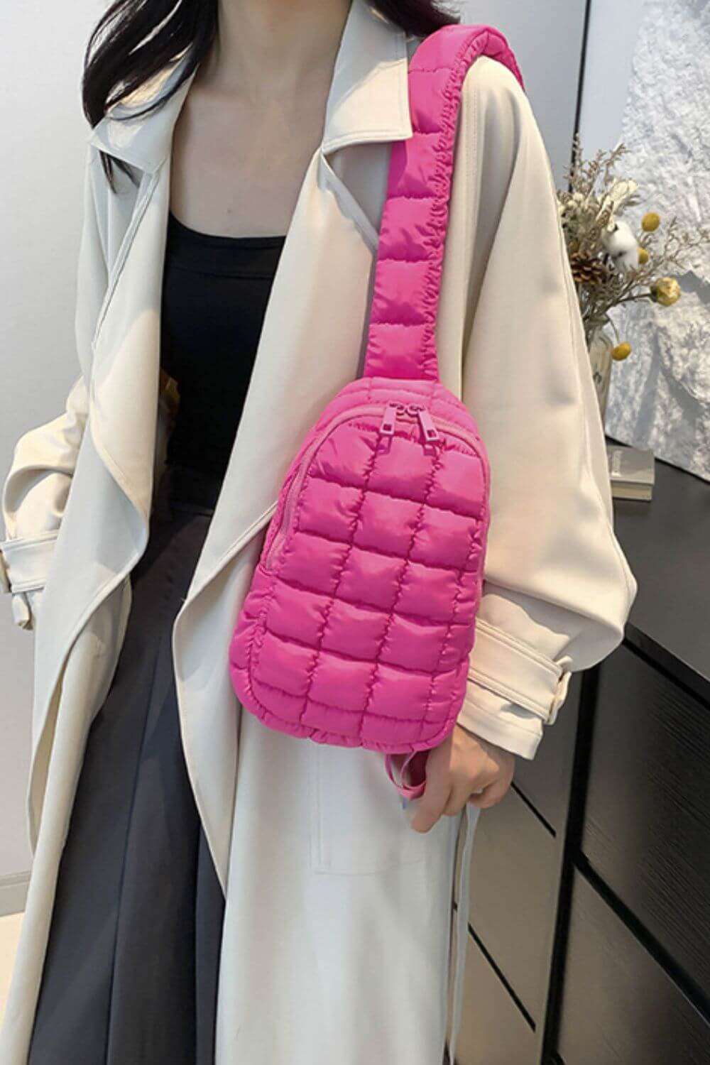 Trendy pink Bella Road Quilted Nylon Crossbody Bag worn by a person, showcasing its stylish and lightweight design.