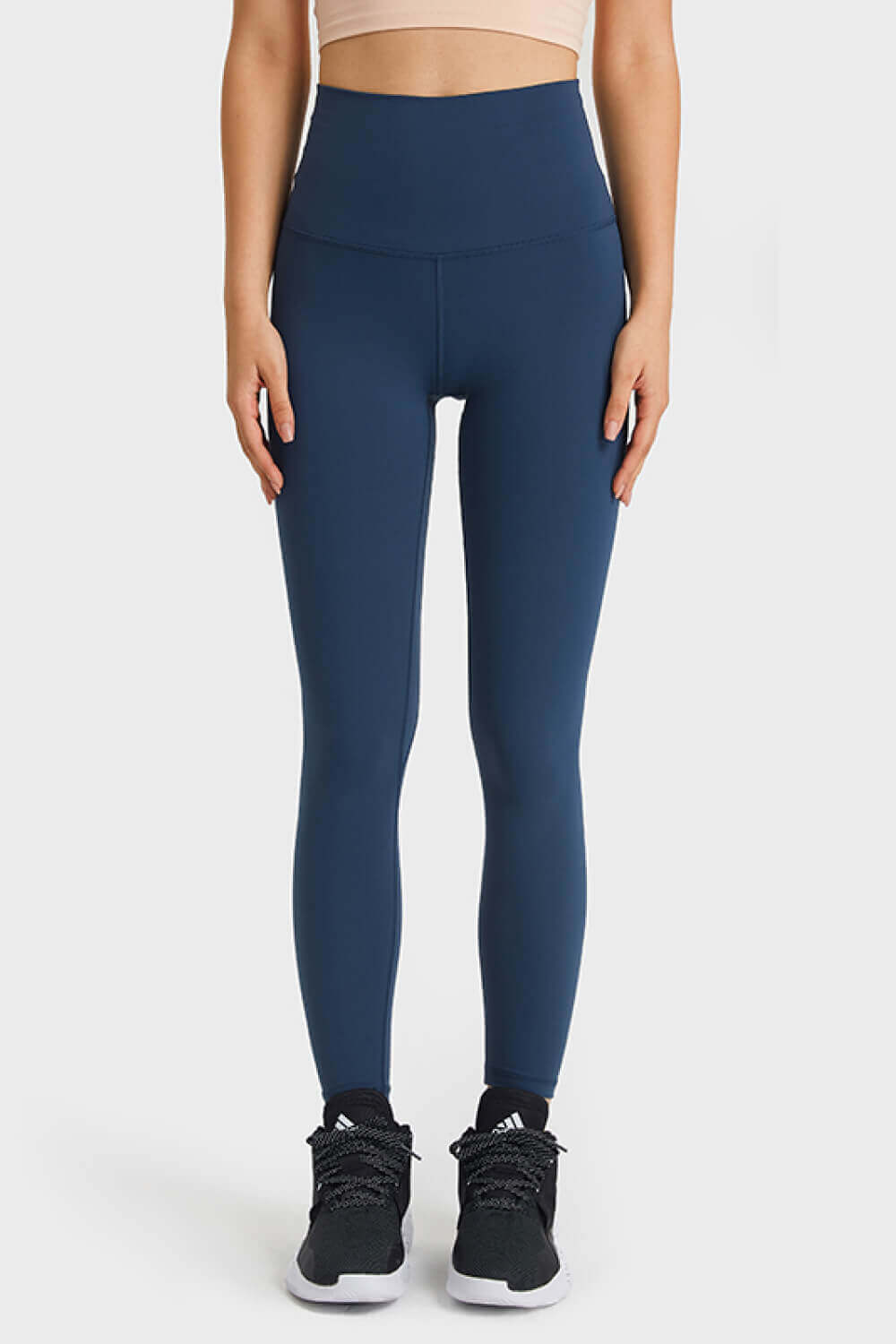 Model wearing Millennia Ultra Soft High Waist Leggings in navy, perfect for yoga and casual athleisure styles.