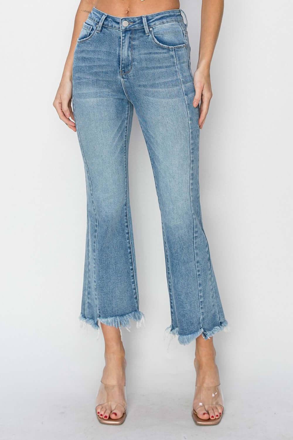 Trendy high rise frayed hem flare jeans, Risen Jeans, offer a stylish and elongating silhouette with a touch of bohemian charm.