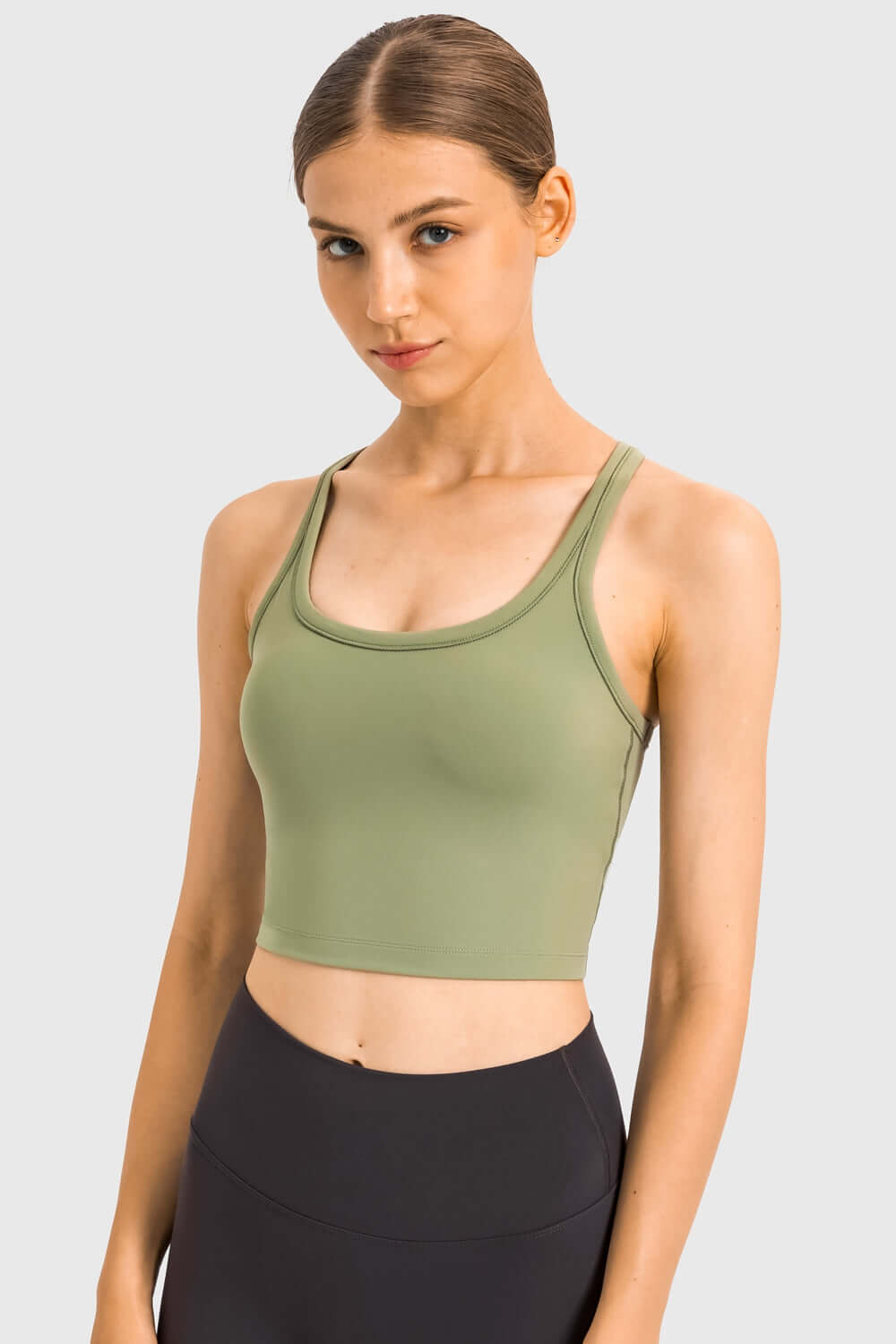 Millennia Racerback Sports Bra in olive green, showcasing a sleek design ideal for yoga and workouts.