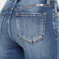 High Waist Distressed Raw Hem Ankle Skinny Jeans with trendy back pocket detailing and edgy worn-in look