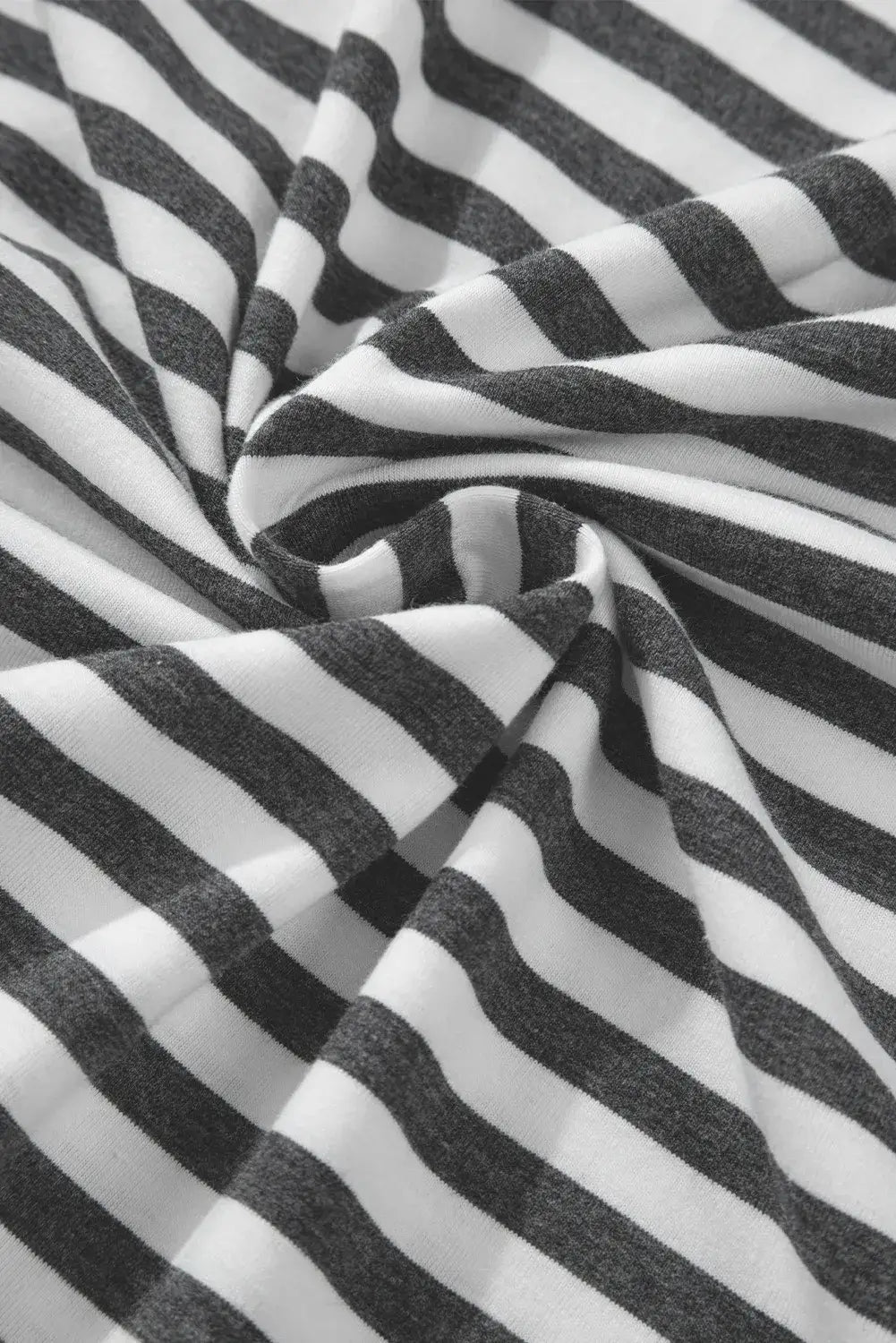 Close-up of Bella Road striped fabric with black and white stripes, showcasing the stylish pattern of the round neck long sleeve top.