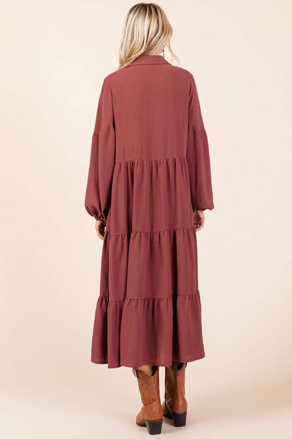 Woman wearing Mittoshop tiered button down long sleeve midi dress in rose brown, showcasing back view and elegant silhouette.