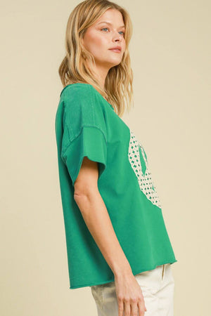 Umgee green mineral wash t-shirt with lace applique, offering a stylish and comfortable fit for plus-size fashion.