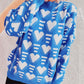 Model wearing Bella Road Heart Contrast Long Sleeve Dropped Shoulder Sweater in blue and white heart pattern