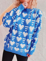 Model wearing Bella Road Heart Contrast Long Sleeve Dropped Shoulder Sweater in blue and white heart pattern