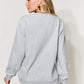 Woman wearing grey letter graphic long sleeve sweatshirt in full size, showing back view.