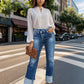 Woman wearing Stepped Waist Raw Hem Rolled Straight Jeans on city street