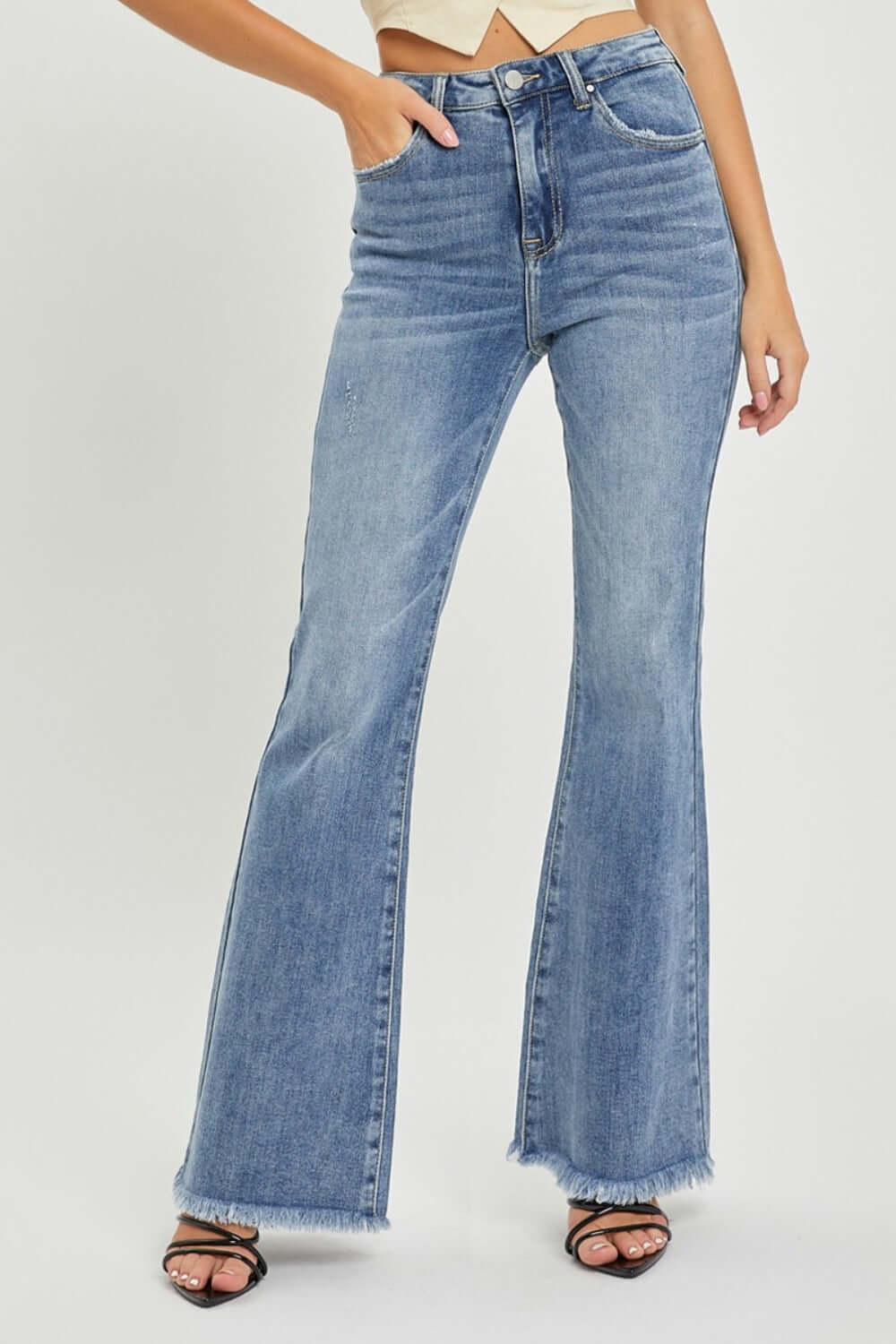 High Waist Raw Hem Flare Jeans with a retro-inspired look, featuring a flattering high-rise waist and flare leg for a trendy fit