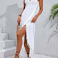 Woman wearing a white backless tassel surplice spaghetti strap cover up dress with a high-low hemline.