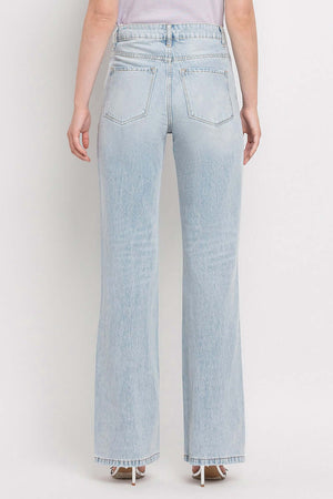 Back view of 90's Vintage Super High Rise Flare Jeans showcasing high-rise waist and wide flare legs in light blue denim