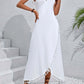 Woman wearing a white backless tassel surplice spaghetti strap cover up dress