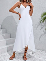 Woman wearing a white backless tassel surplice spaghetti strap cover up dress