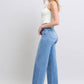 Judy Blue wide leg jeans with pockets, showcased on model, perfect for stylish and relaxed outfits.