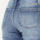 High waist distressed hem detail cropped straight jeans back view. Trendy edgy denim with a lived-in look, showcasing stylish rear pockets.