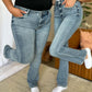 Two people wearing Judy Blue full size medium rise bootcut jeans, demonstrating a comfortable and stylish fit for all body types.