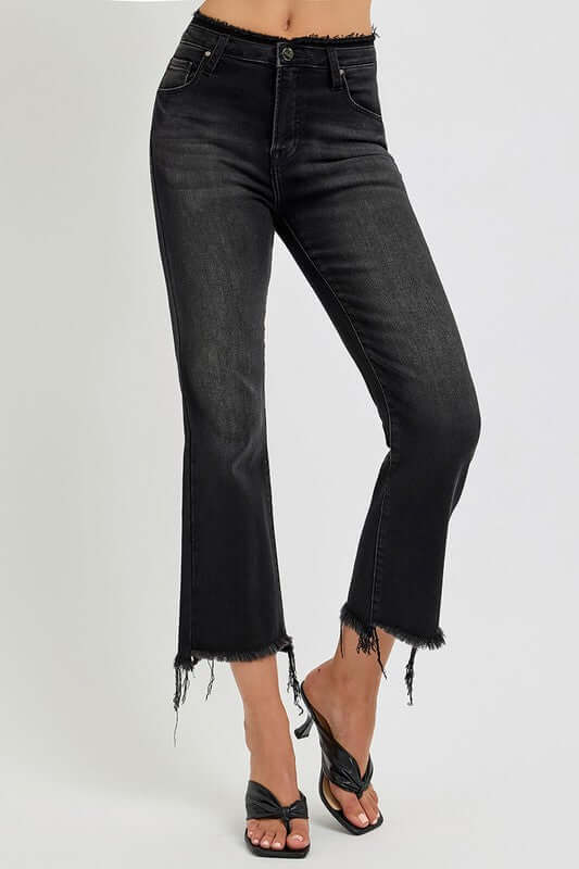 Trendy plus size raw hem cropped flare jeans with a stylish black wash and casual vibe.