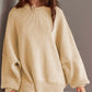 Woman wearing Double Take Side Slit Round Neck Long Sleeve Sweater in beige color