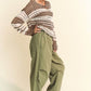 Davi & Dani Contrast Striped Crochet Drop Shoulder Knit Cover Up styled with loose olive pants and sneakers.