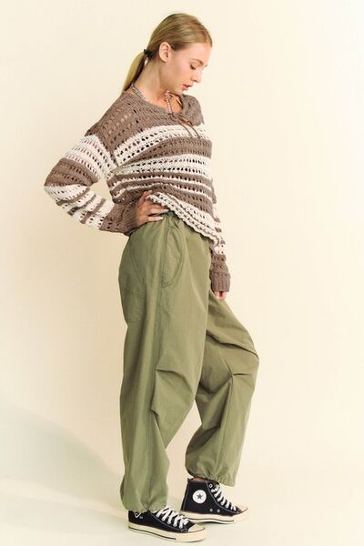 Davi & Dani Contrast Striped Crochet Drop Shoulder Knit Cover Up styled with loose olive pants and sneakers.