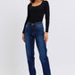 Woman wearing Judy Blue Full Size Raw Hem Straight Leg Jeans with a black top, showcasing a stylish and versatile look.