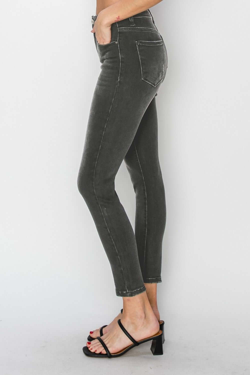 High Rise Ankle Skinny Jeans highlighting a woman's legs and curves, featuring a slim fit and high-waisted design for an elongated silhouette.